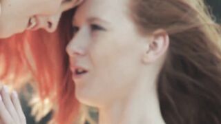 Watch these two hot redheads have wild lesbian sex on the beach